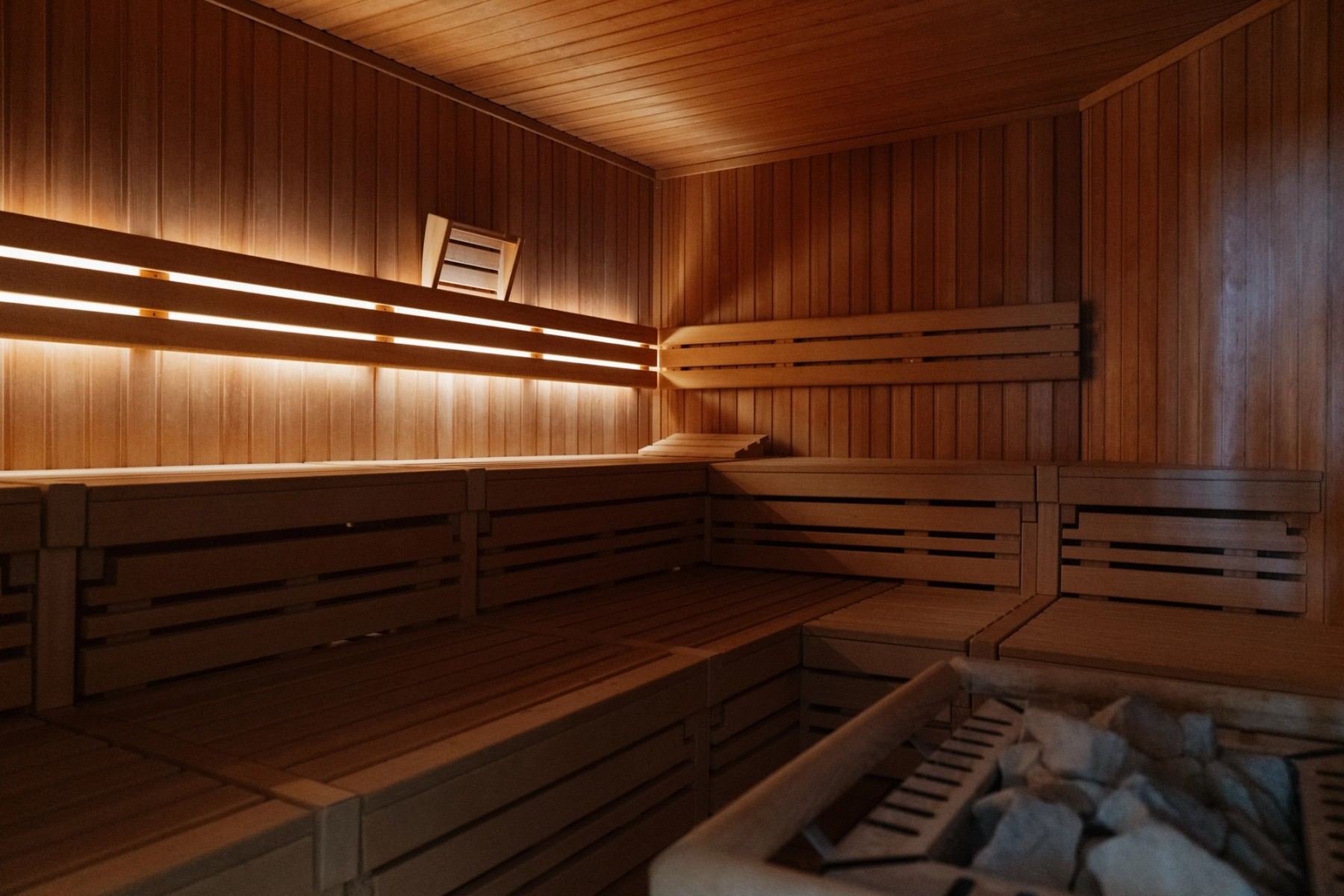Finnish sauna with wooden benches and warm light