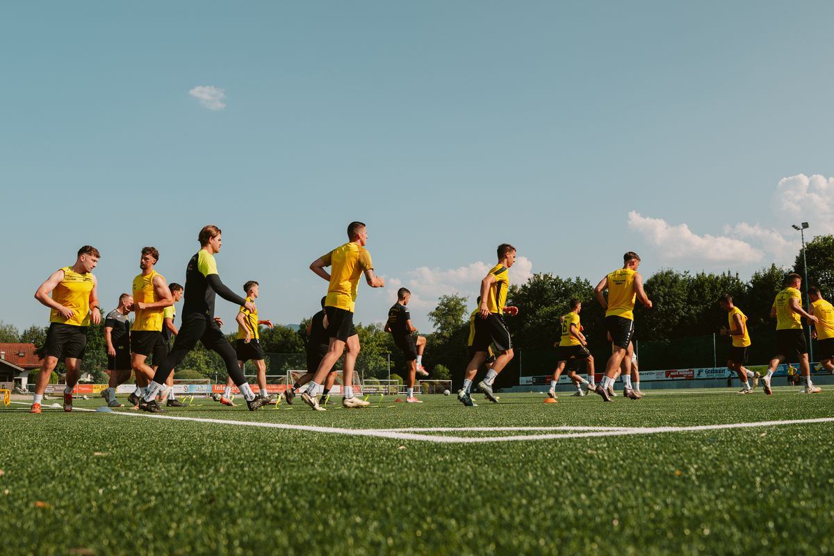 The team warming up on the grass pitch