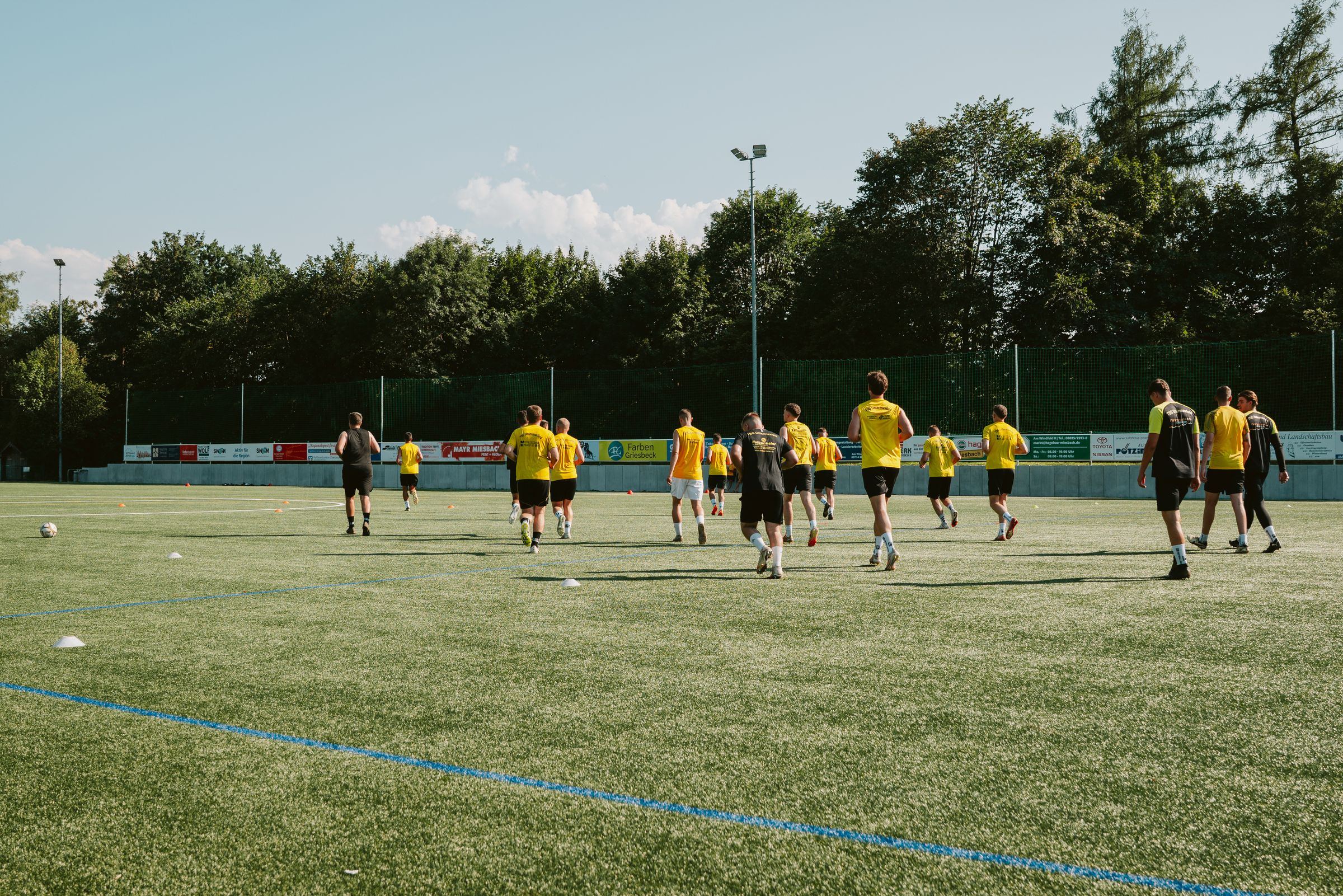 A team warming up on the grass pitch